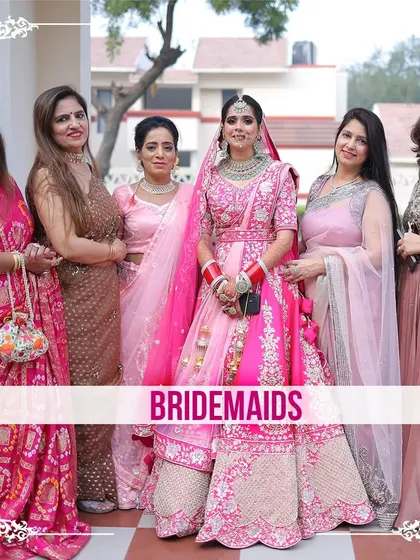 A bride surrounded by her bridesmaids, all dressed in shades of pink, a beautiful portrait of friendship and support.
