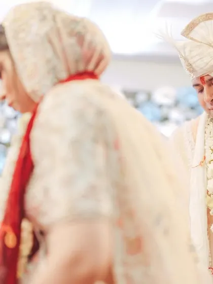 A soft, emotional shot of the couple during their vows, capturing the gravity and beauty of their commitment.