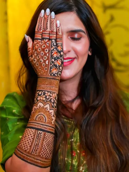 A side view highlighting the detailed bands of patterns on the forearm. The design includes a mix of traditional Indian and Arabic styles for a modern look.