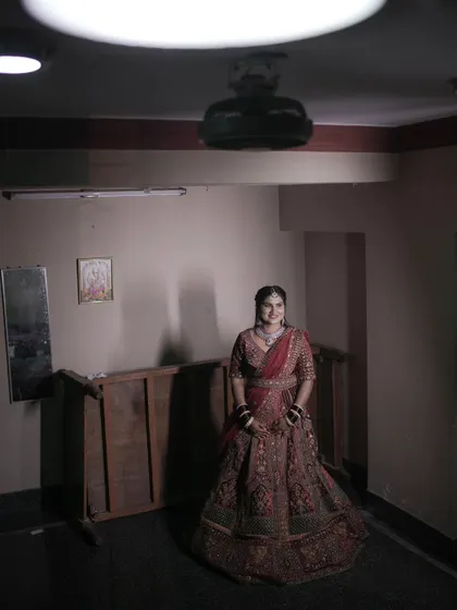 A full-length portrait of the bride in her beautiful reception outfit, ready to make her entrance.