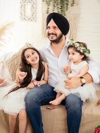 A father's joy is evident in this photo with his two lovely daughters.