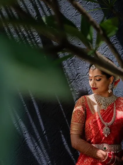 A creative portrait of the bride, using reflections and shadows to create a sense of mystery and art. We love experimenting with different techniques to tell a unique story.