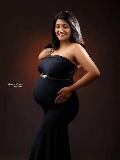 A simple black gown can be incredibly powerful. This portrait captures a moment of pure joy and anticipation, with a smile that lights up the frame.