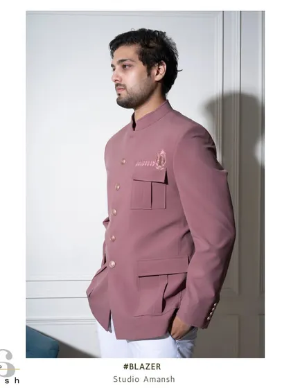 The side profile of the pink Prince Coat showcases its structured fit and practical yet stylish pocket design. It's a modern take on a heritage silhouette, perfect for a summer wedding.