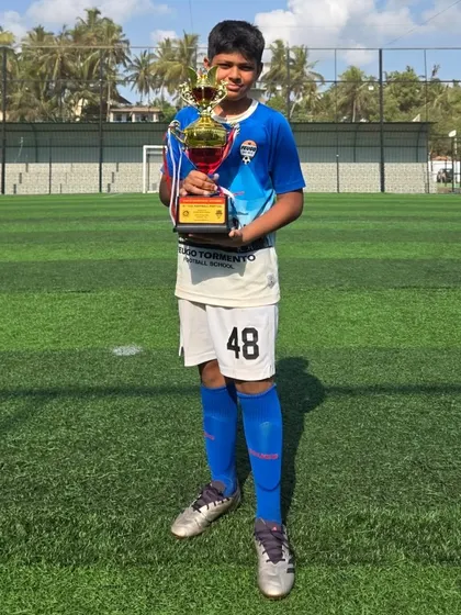 This U14 player holds his team's trophy after a great tournament.