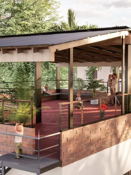 A render showing the rooftop terrace designed for community activities. The space features a cool red oxide floor, a protective roof for shade, and built-in seating along the edges. This addition significantly increased the usable area of the school without a large expense.