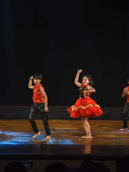The kids' troupe moving together as one, showcasing the results of their hard work and practice.