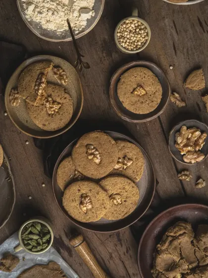 A close-up detail shot from the jowar walnut cookie flatlay, focusing on the texture and arrangement.