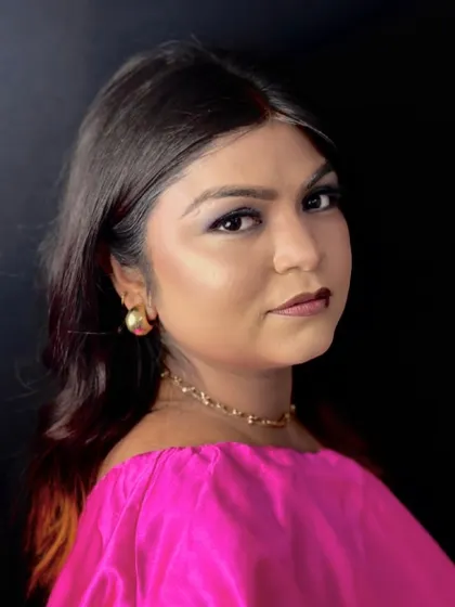 A portrait shot capturing the intensity of the dark eye makeup and the overall confident vibe of this student-created look.
