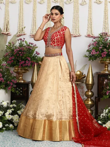 The sheer red dupatta adds a touch of romance and drama to this elegant lehenga set.