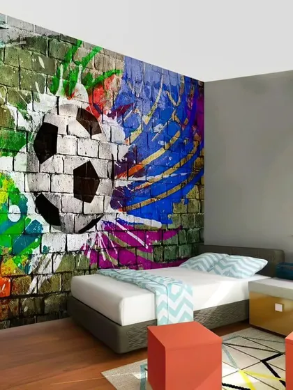 A football-themed bedroom with a dynamic graffiti-style wall mural, perfect for a young sports fan.