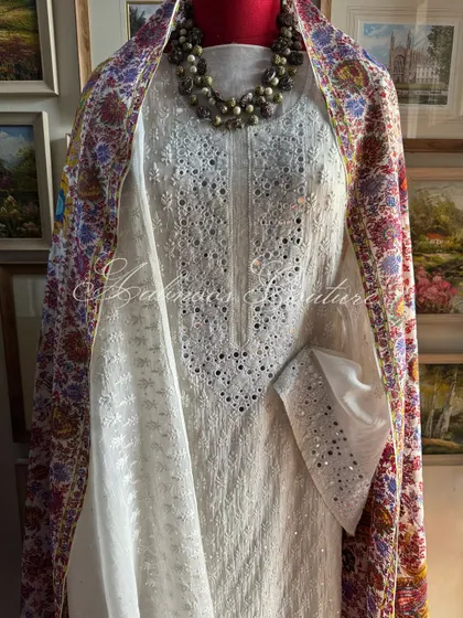 A full view of the ensemble, showing how the vibrant, multi-colored Kashmiri Kalamkari dupatta adds a festive and regal dimension to the classic off-white Chikankari suit.