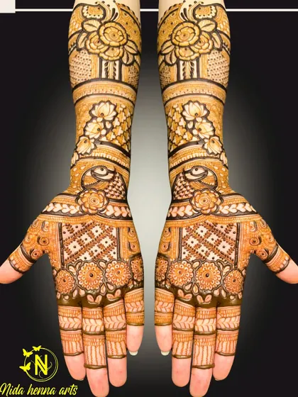 A classic Indian bridal design with full coverage. The pattern is symmetrical on both hands and features traditional elements like the evil eye motif and floral jaal work.