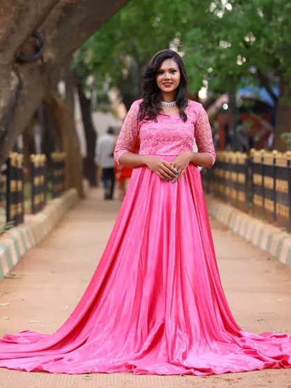The pink rental gown looks beautiful from every angle. It has a delicate lace bodice and a long, flowing skirt that is perfect for capturing movement.