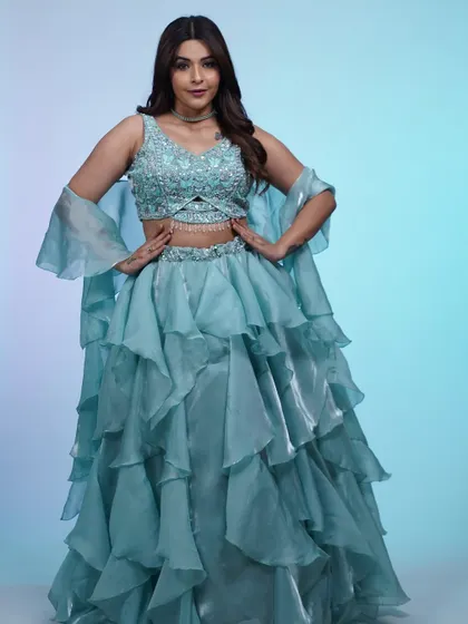 The full look of the ruffled blue lehenga, showing off its incredible volume and movement. It's an outfit that's guaranteed to make you feel like dancing.