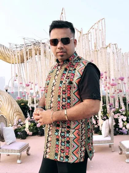 A semi-traditional embroidered vest over a black kurta. This is a great look for events that call for a blend of modern and ethnic style.