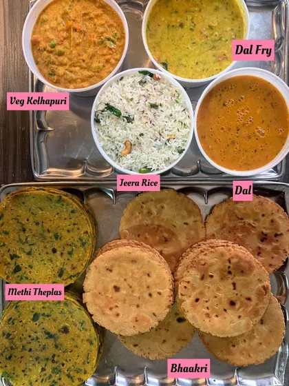 A perfect Sunday meal. This order included Veg Kolhapuri, Dal Fry, Jeera Rice, Methi Theplas, and Bhaakri, a wholesome and flavorful combination.