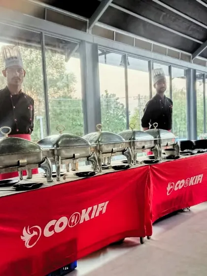 A scenic buffet setup for a house party, with our team ready to serve against a beautiful backdrop.