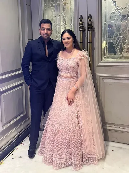 This happy client chose a beautiful pink lehenga with a feather-detailed cape for her event. It’s a perfect blend of traditional and modern style.
