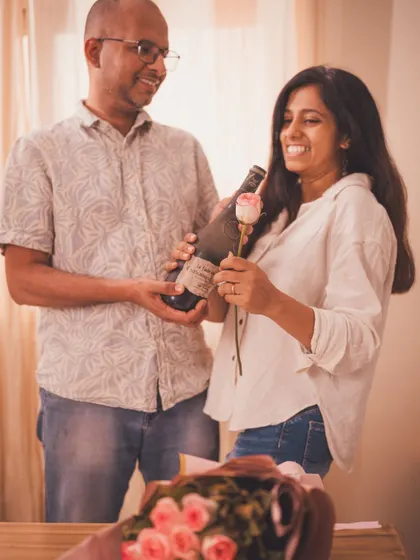 A candid, happy moment between a couple celebrating with the featured wine, perfect for a lifestyle brand narrative.