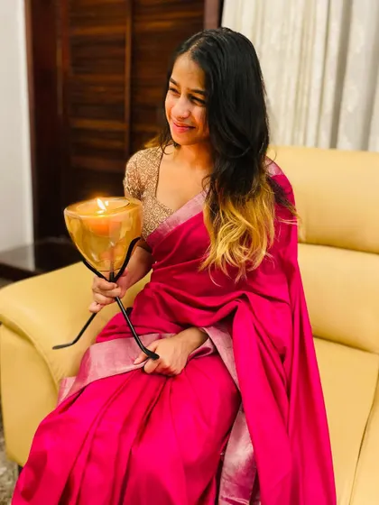 Holding a candle to celebrate the light and joy of Navratri. The simple elegance of this pink saree is perfect for the final day.