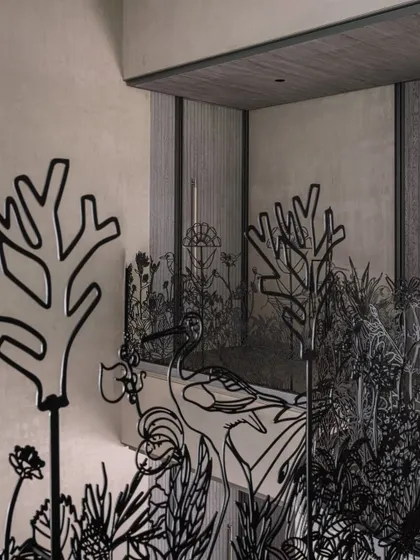 Another angle of the nature-inspired metal railing, this shot emphasizes how the piece interacts with the home's interior architecture, creating layers of visual interest.