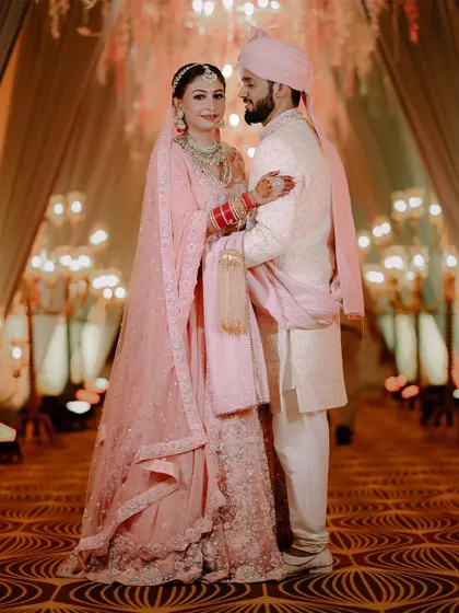 A full-length portrait showcasing the couple's coordinated wedding attire.