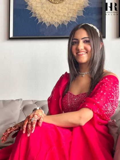 A candid shot of the client looking happy and confident in her full glam look.