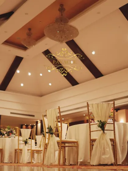 A low-angle shot of the guest seating, highlighting the chandeliers in the banquet hall.