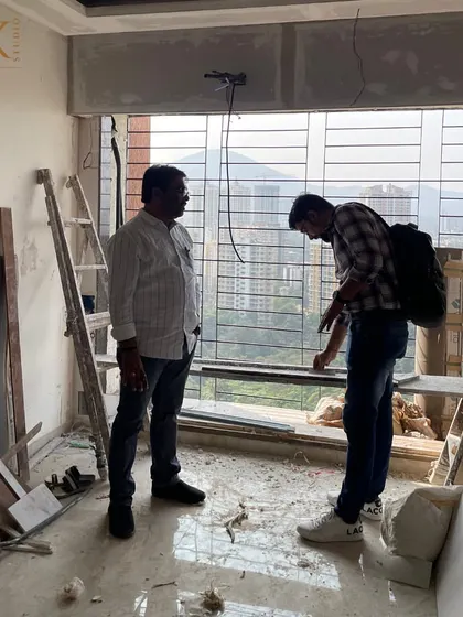 A site visit is where the real planning happens. Here, I am discussing the layout and possibilities with my client, right inside the space we are about to transform.
