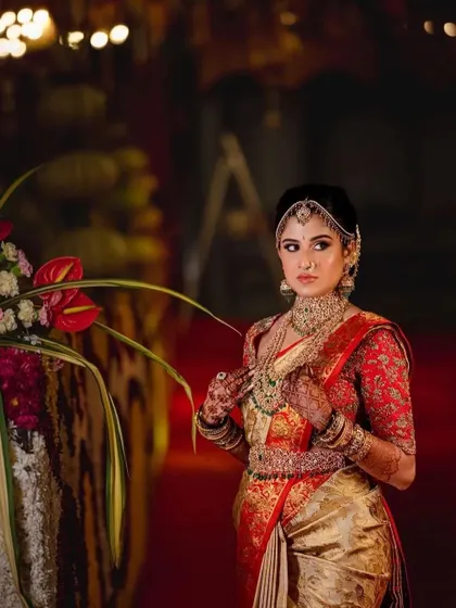 A full-length shot of the bride, where her stained mehndi is an integral part of her traditional attire.