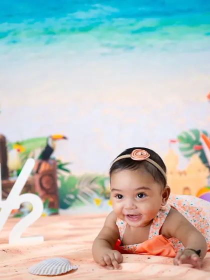 Celebrating a half-birthday with a beach theme. This little one is enjoying some tummy time on the sand.