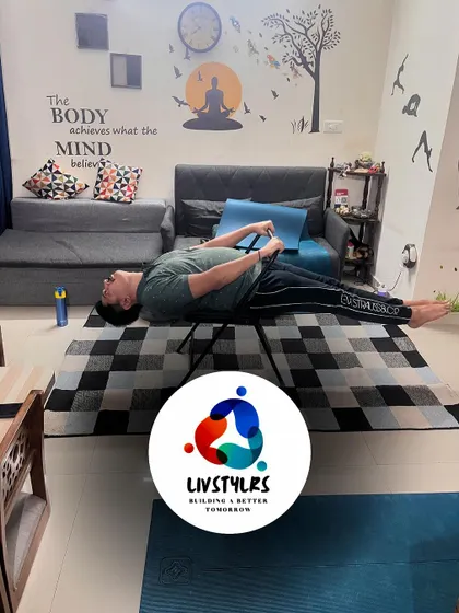 A client performs a core exercise on a yoga chair, showcasing the creative use of props.