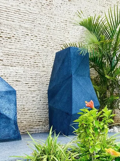 A close-up on the sculptural blue planters, which add a bold splash of color and modern artistry.