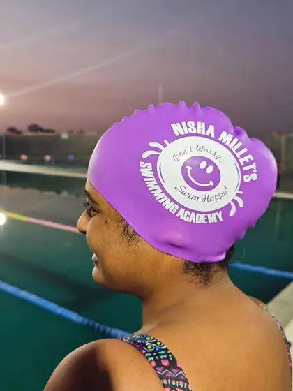 We love that our swimmers are rocking the NMSA merch in the pool. Our academy motto is "Don't worry, Swim happy!" and this purple cap shows it off with style.
