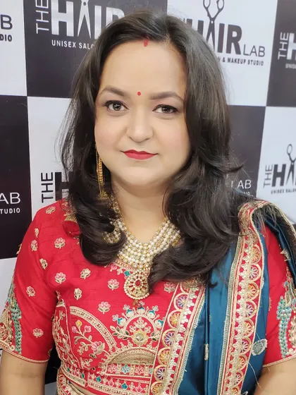 This client is glowing and ready for the party. I gave her soft, face-framing hair layers and makeup that highlights her features, paired with her embroidered outfit.