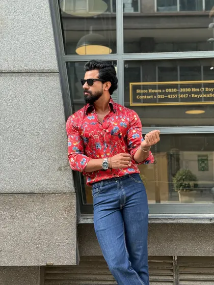 A relaxed pose against an urban backdrop, this image showcases the shirt's eye-catching design and comfortable fit.