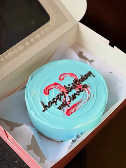 A lovely blue bento cake for a 22nd birthday celebration. The message "happy birthday my love" is written over a red and white brushstroke heart design.