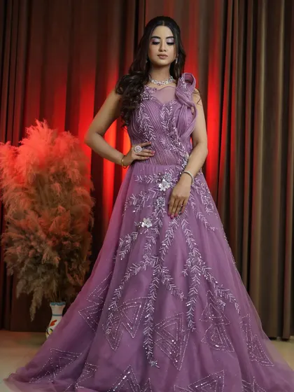 A confident pose in our onion pink bridal gown. This rental piece is designed to make a statement from every angle, ensuring you are the center of attention.