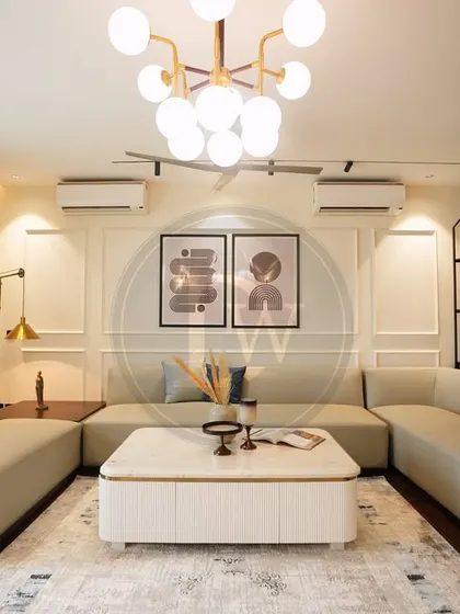 Another angle from our recent project, showcasing the U-shaped sectional sofa that creates a cozy and inclusive conversation area. The white coffee table with gold accents adds a touch of modern glamour.