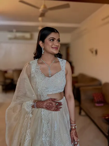 A sleek and elegant half-up style with soft waves at the ends. This is a very polished look, perfect for an engagement or reception.