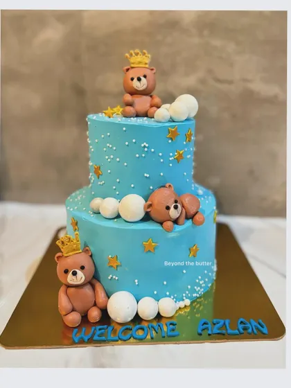 A royal welcome for baby Azlan. This two tier cake is decorated with adorable, crown wearing teddy bears, fluffy clouds, and golden stars for a dreamy "twinkle twinkle little star" theme.