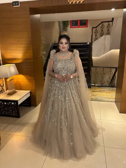 A full-length shot showing the magnificent gown and the glamorous makeup. She looks like she stepped right out of a fairytale, ready for her reception.