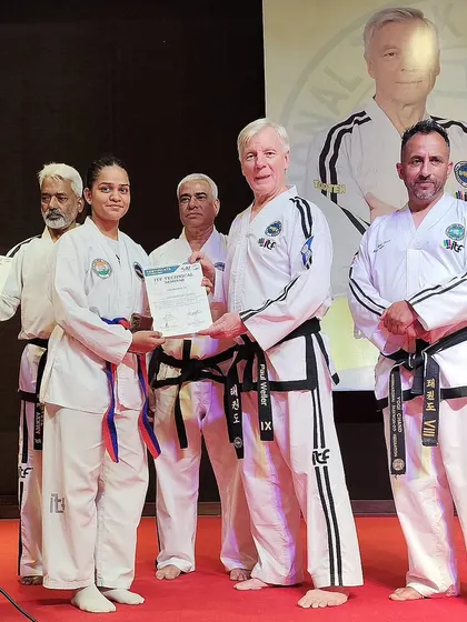 One of our students, Shivani Gupta, receives her certificate for completing the ITF Technical Course from ITF President Grandmaster Paul Weiler.