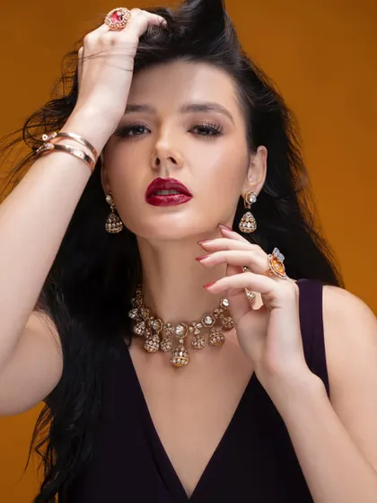 A glamorous shot from a jewellery campaign, featuring a bold red lip and windswept hair. I styled the model with an ornate gold and diamond necklace that exudes luxury and sophistication.