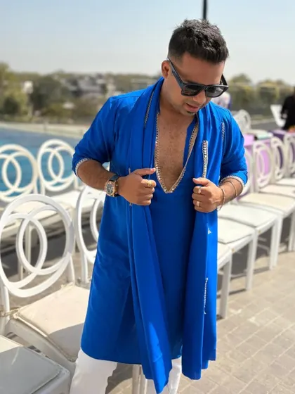 Adjusting my outfit before I take the mic. Every detail matters when you're creating a perfect event experience. Ready to host this blue-themed Haldi.