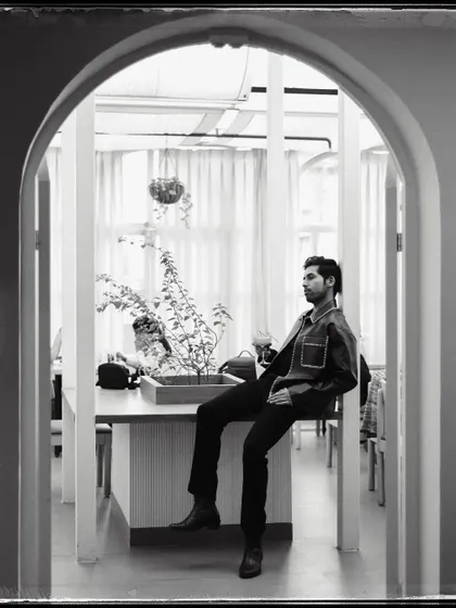 Isshaan, framed by a series of archways. The architecture creates a wonderful sense of depth and perspective in this black and white shot.
