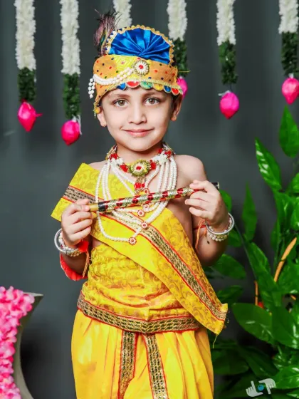 A charming portrait of a young boy dressed as Krishna for a festive photoshoot. Our studio setups include vibrant props and backgrounds to bring these themes to life.