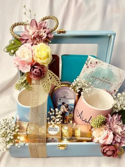 Celebrating love stories is a joy, and this engagement hamper is designed to do just that. It includes personalized "Mr" and "Mrs" mugs, matching passport covers for future adventures, and a photo candle to light up their new journey.