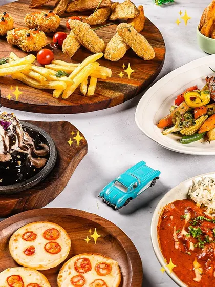 A fun and delicious spread from our kids' menu, complete with mini pizzas, fries, and a sizzling brownie.